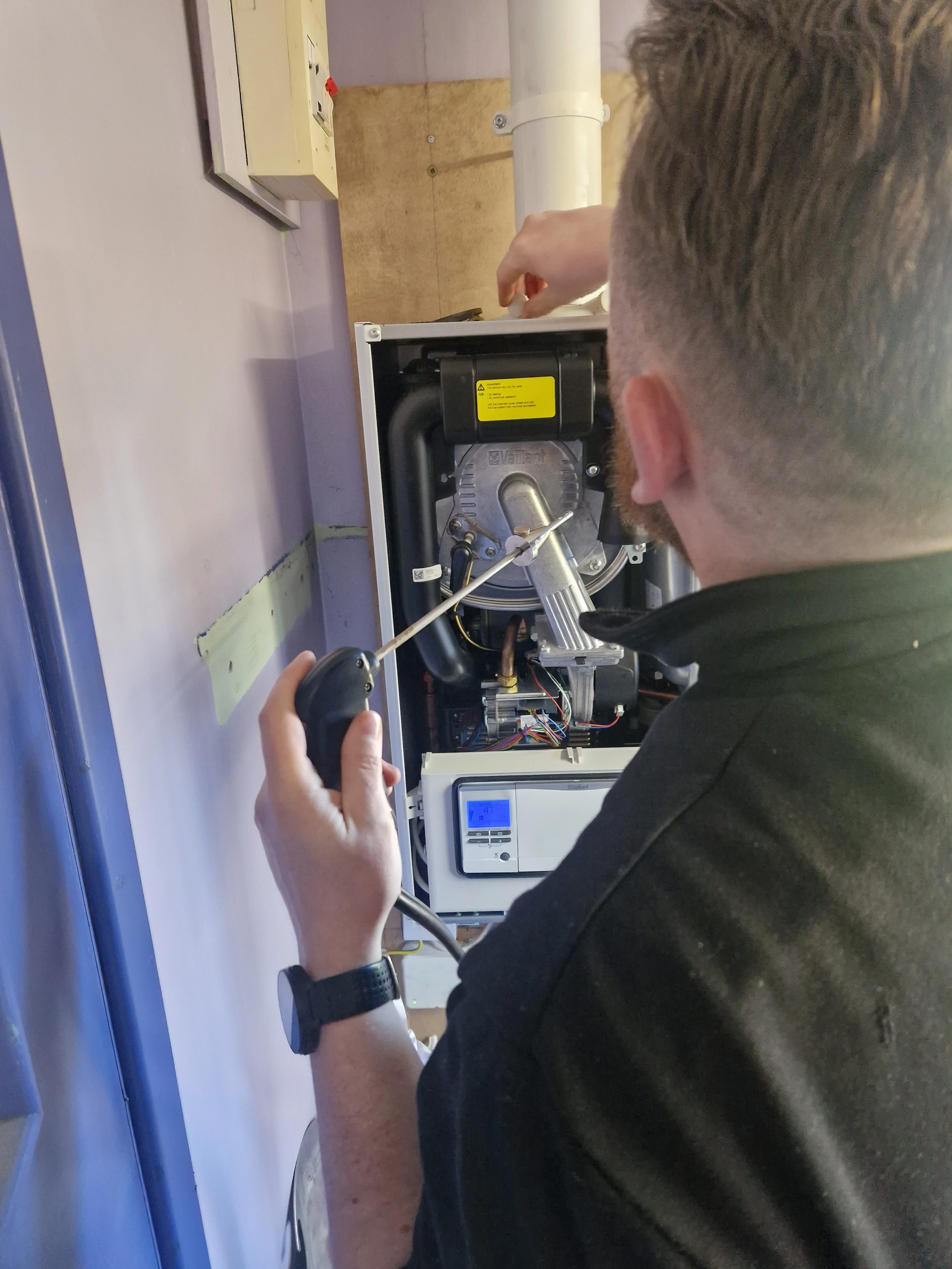 Kieran Kelly commissioning a newly installed gas boiler — Kelly Heating NI, serving Dunmurry and south-west Belfast