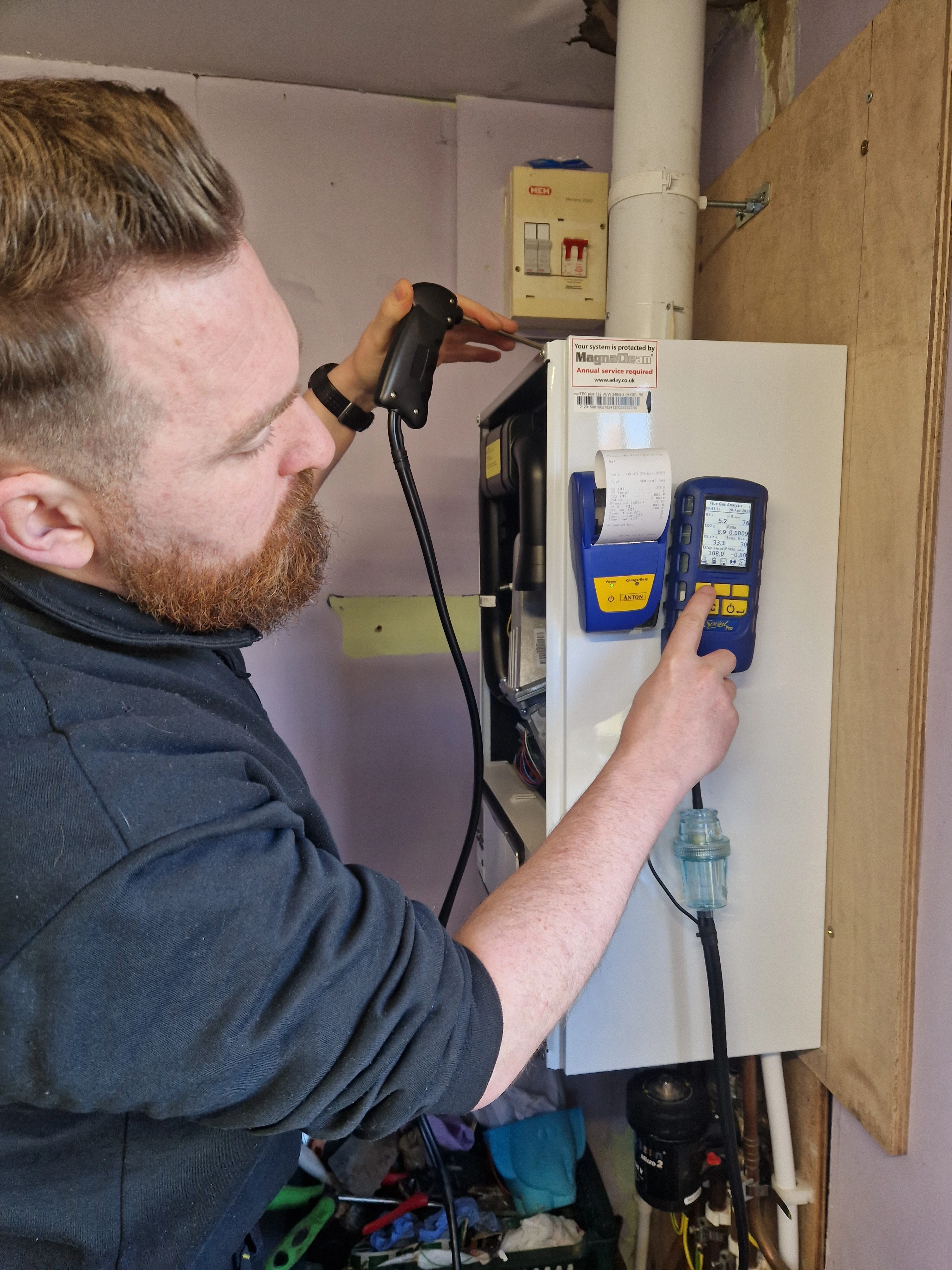 Kieran Kelly using gas analyser to commission a new boiler in Dunmurry 