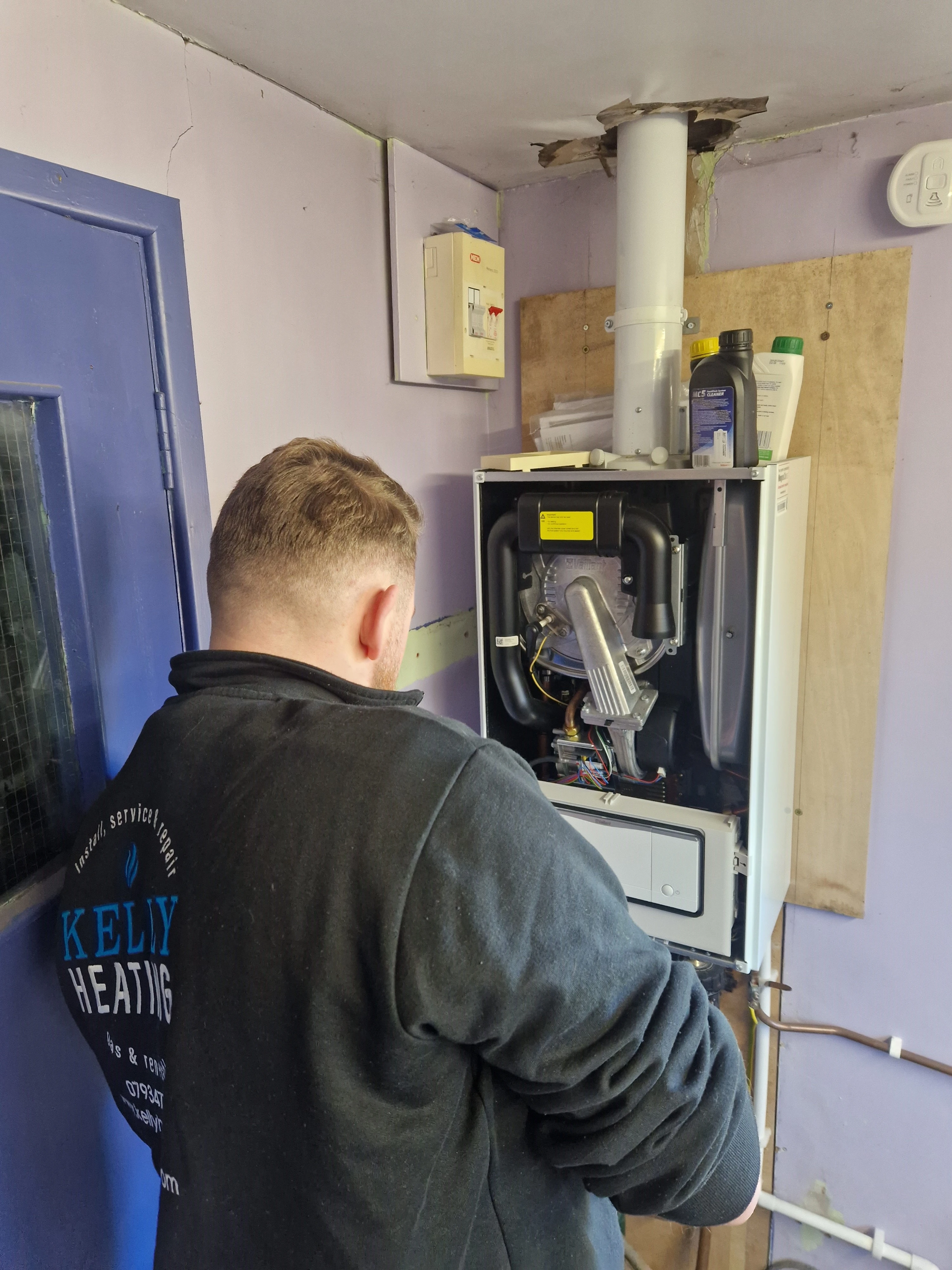 Kieran Kelly installing a gas boiler at a Lisburn property — Kelly Heating NI