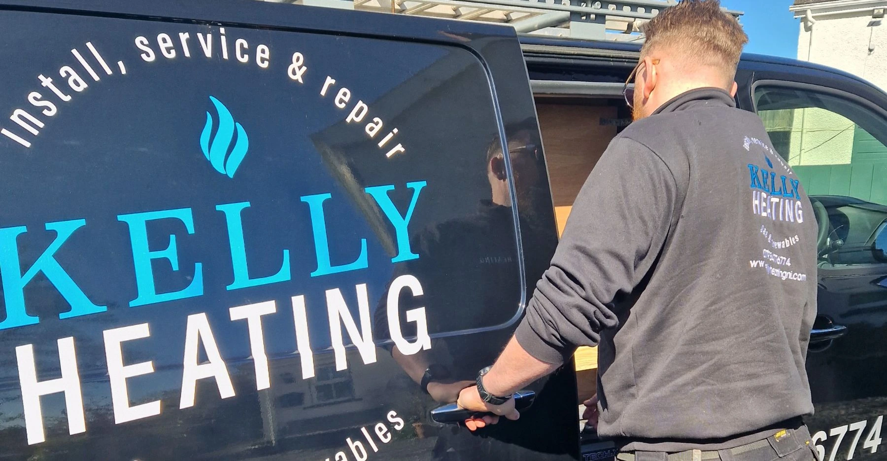 Kelly Heating NI engineer loading tools from Gas Safe van for a Belfast boiler installation callout