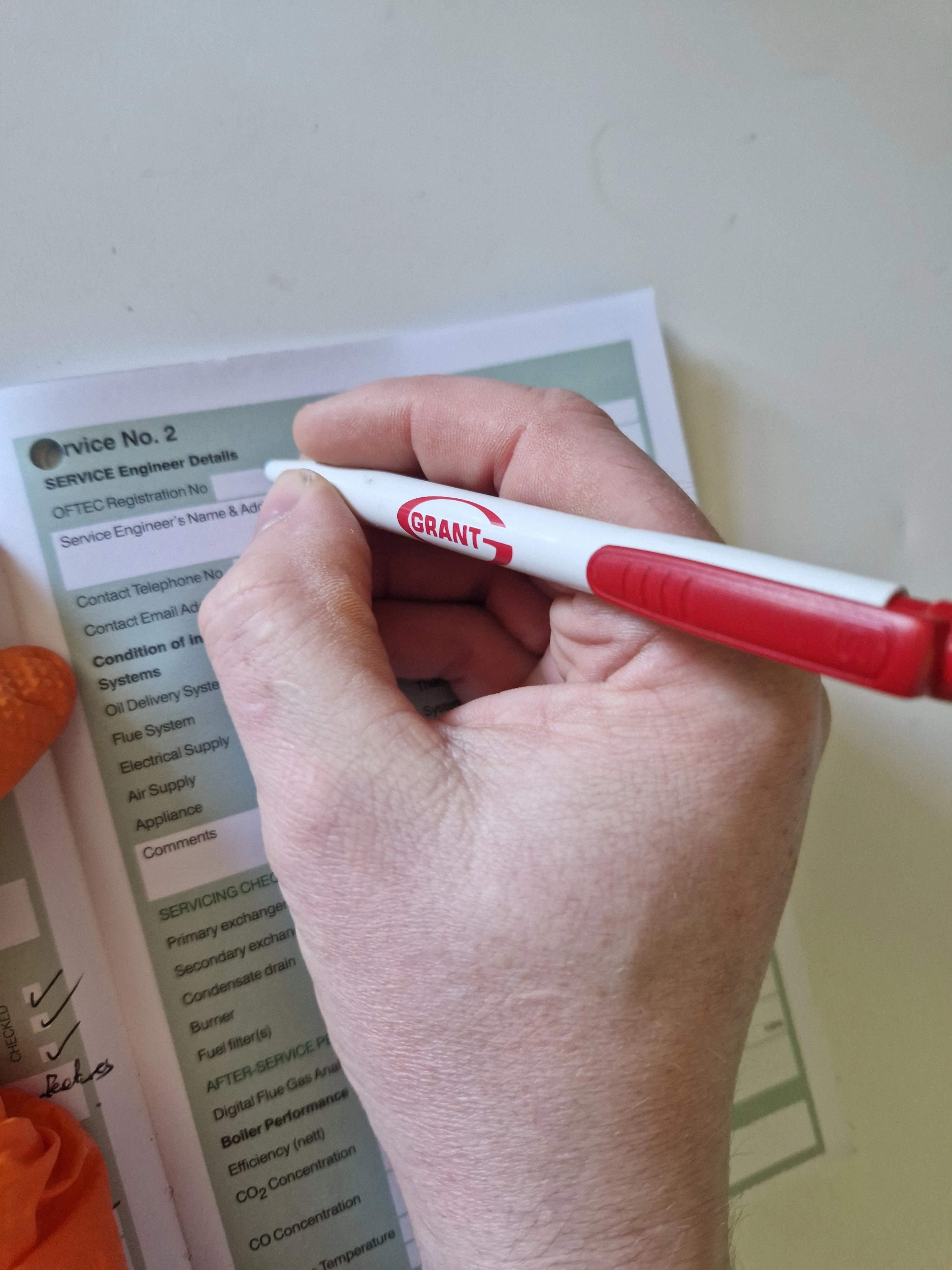 OFTEC oil boiler completion certificate being signed by Kieran Kelly — Kelly Heating NI, Lisburn